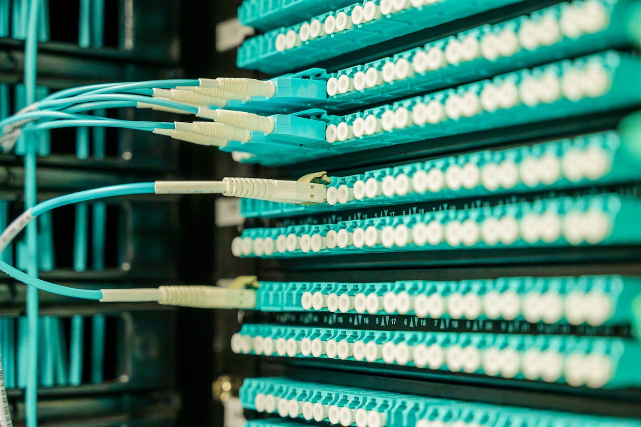 mobile-01 Networking cables plugged into a patch panel, showcasing data center connectivity.